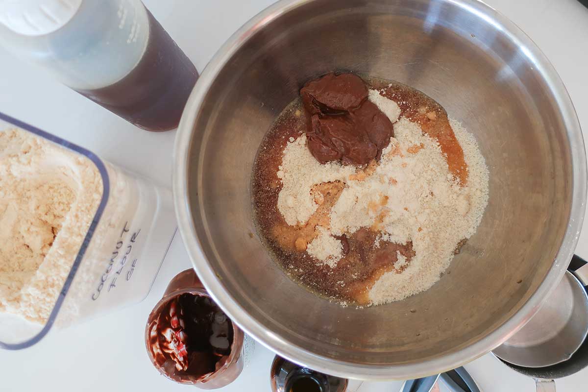 ingredients to make no bake grain free cake pop batter, almond flour, Nutella, vanilla, maple syrup in a bowl
