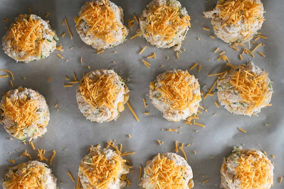 round scones on a baking sheet lined with parchment paper before baking