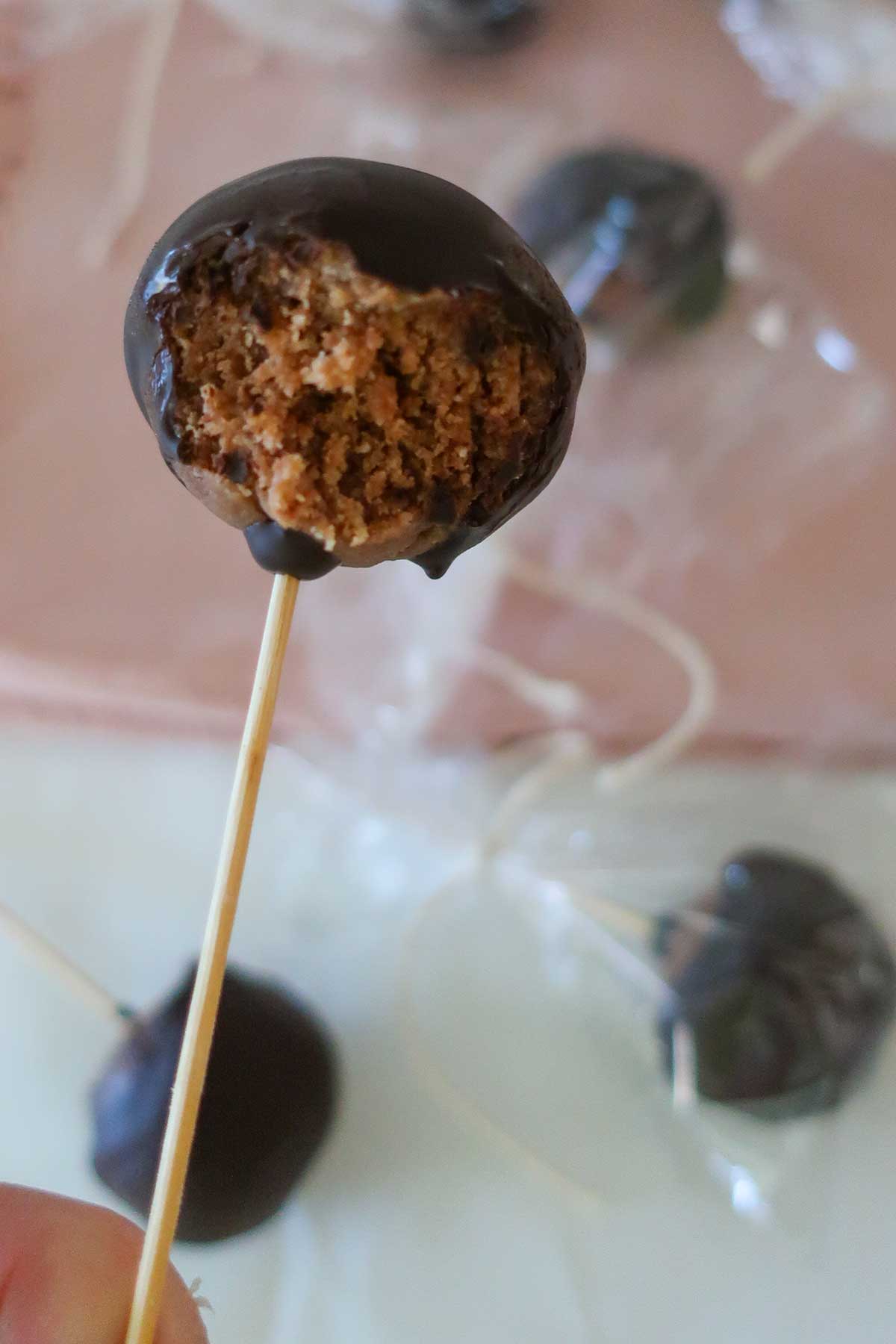 Close-up of a grain-free Nutella cake pop with a moist, fudgy center and a glossy chocolate coating.