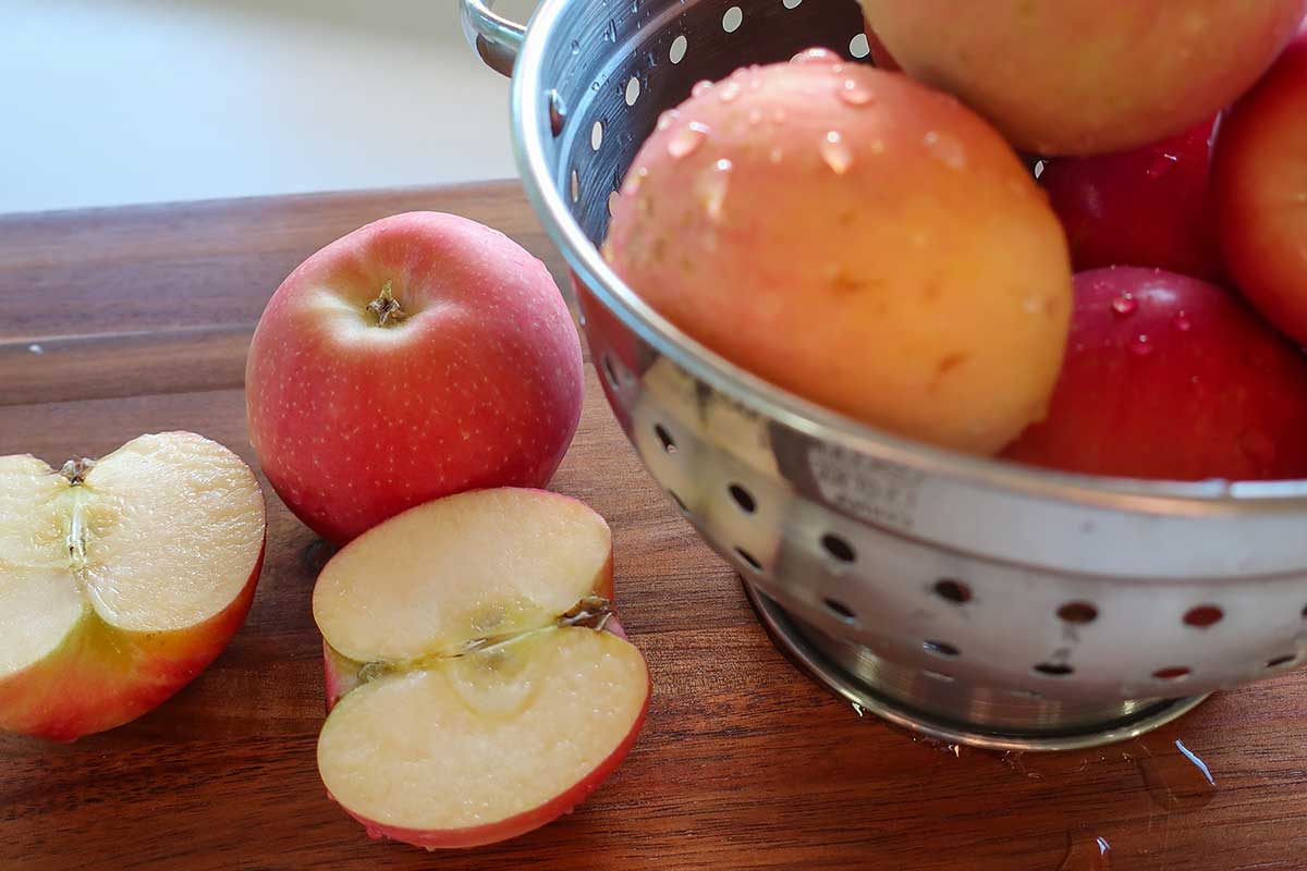 wet apples in a colander with halved one next to it on a cutting board, which apple is best for baking
