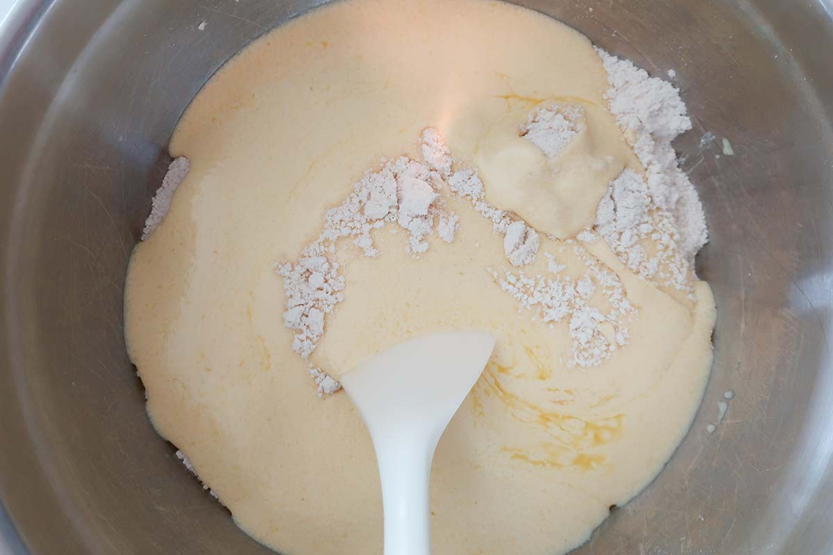 mixing yogurt mixture with flour in a bowl