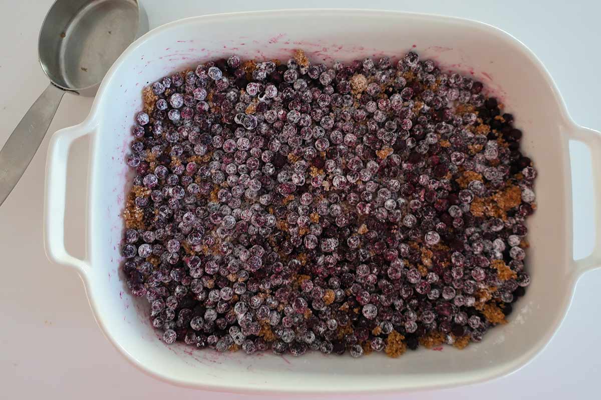 berry dump cake berries in a baking dish coated with tapioca, sugar and cinnamon