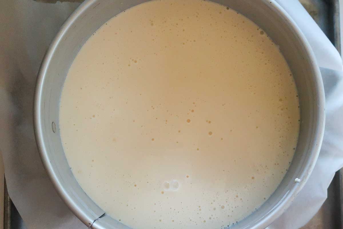 filling poured over partially baked crust in a spring form pan before baking