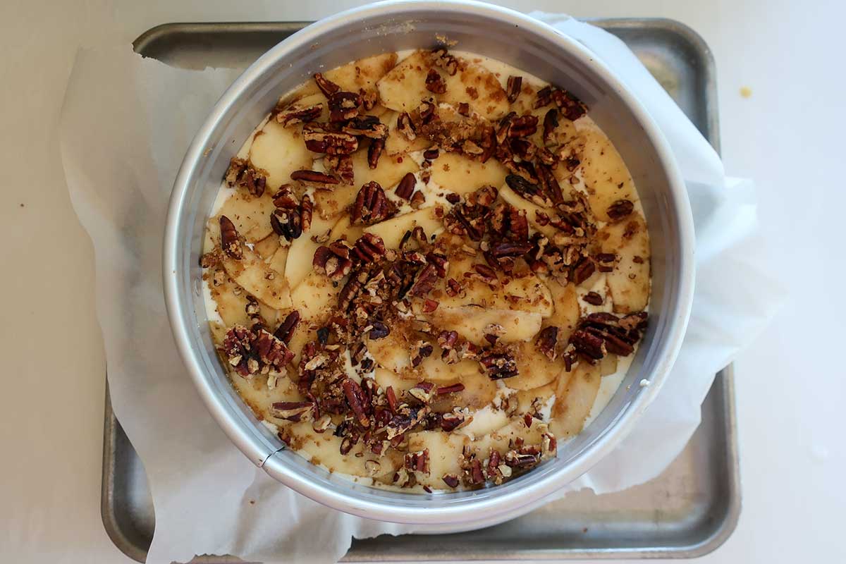 danish apple ricotta cake in a springform pan before baking