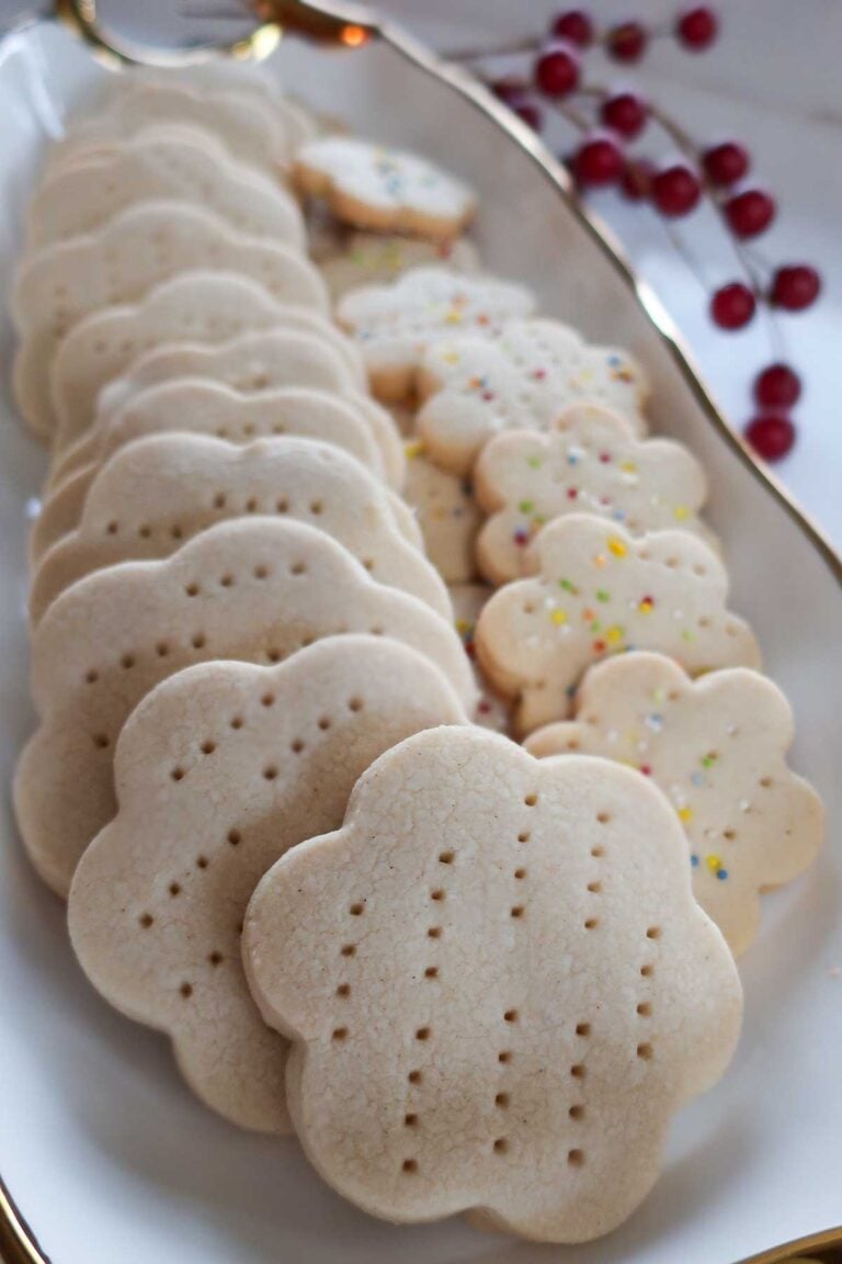 perfectly baked gluten free shortbread cookies lined up on a cookie tray