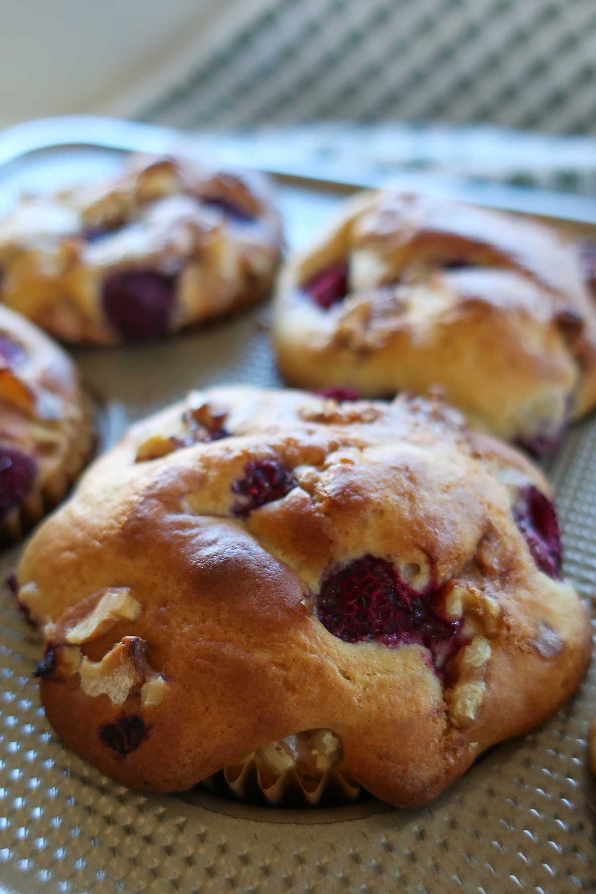 close up of a baked gluten free pancake batter muffins with berries and nuts 