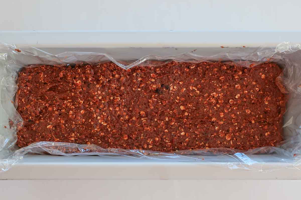 Press the mixture firmly into the pan and chill—no baking required for these chocolate lentil energy bars.