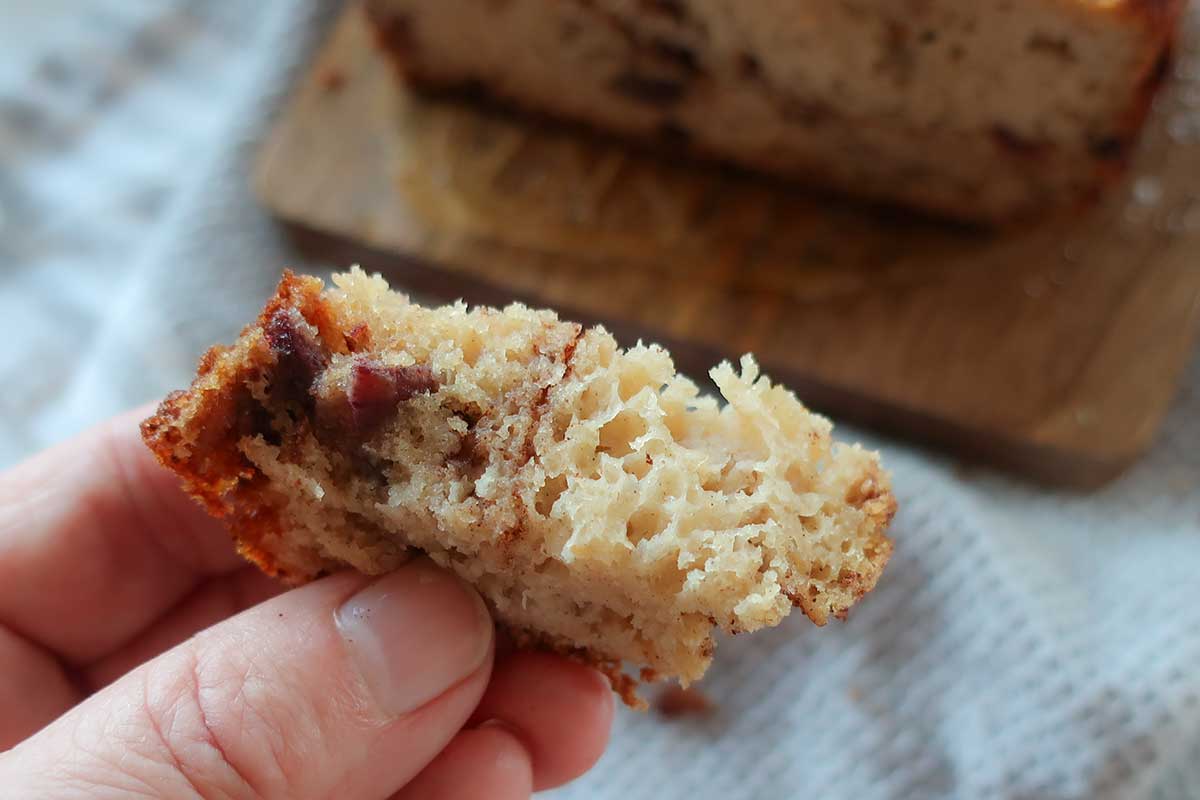 close up of a piece of cinnamon date loaf showing moist tender crumb