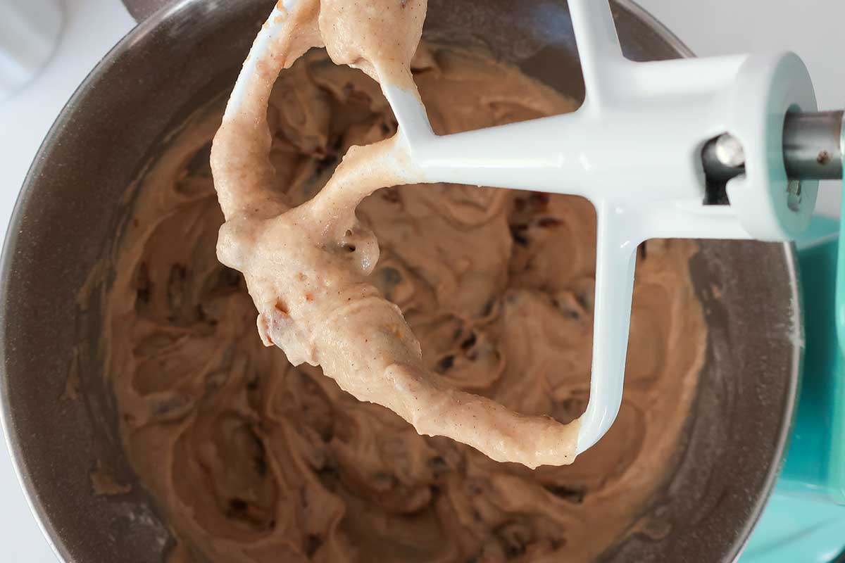 creamy cinnamon date loaf batter in a mixing bowl with a paddle