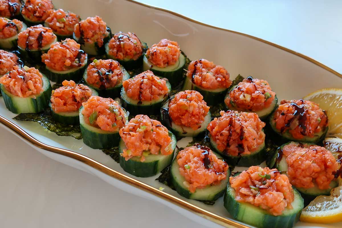 Light drizzle of balsamic glaze over cucumber and salmon bites