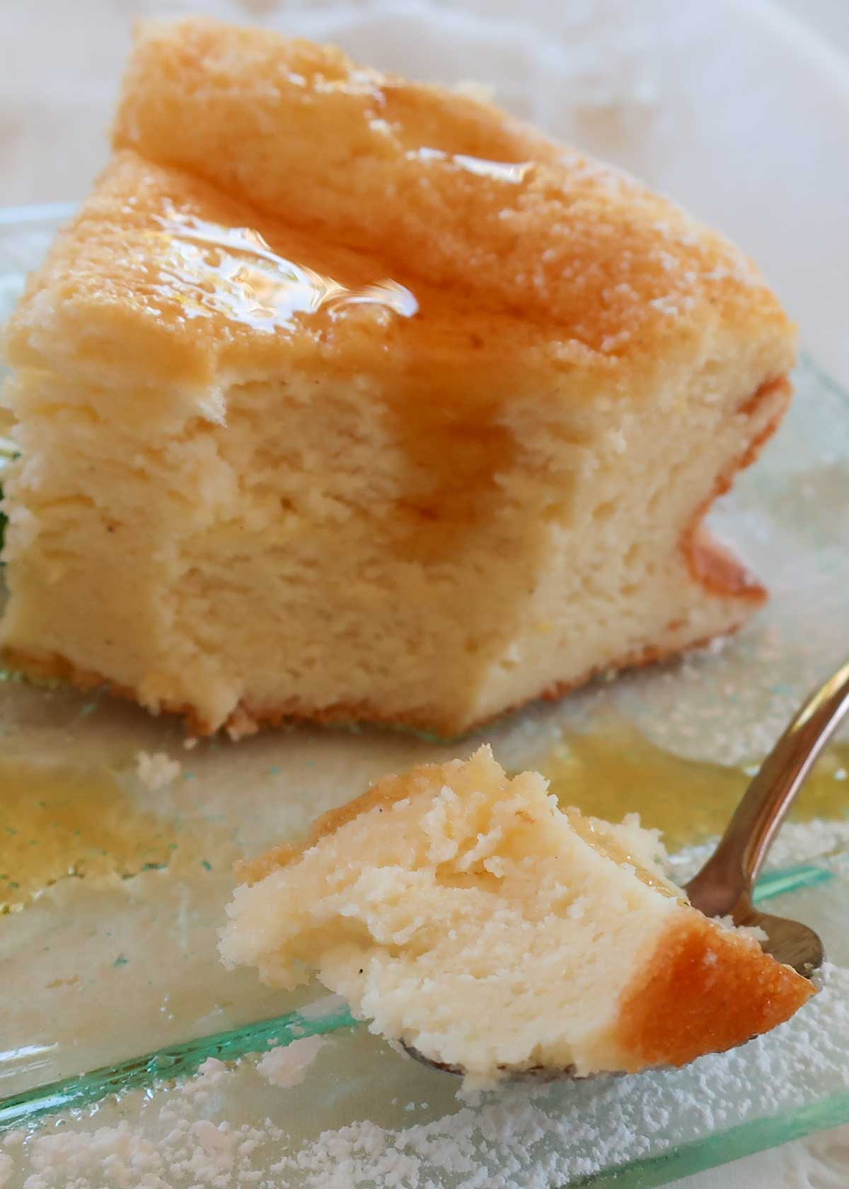 showing the inside creamy texture of the cake drizzled with maple syrup