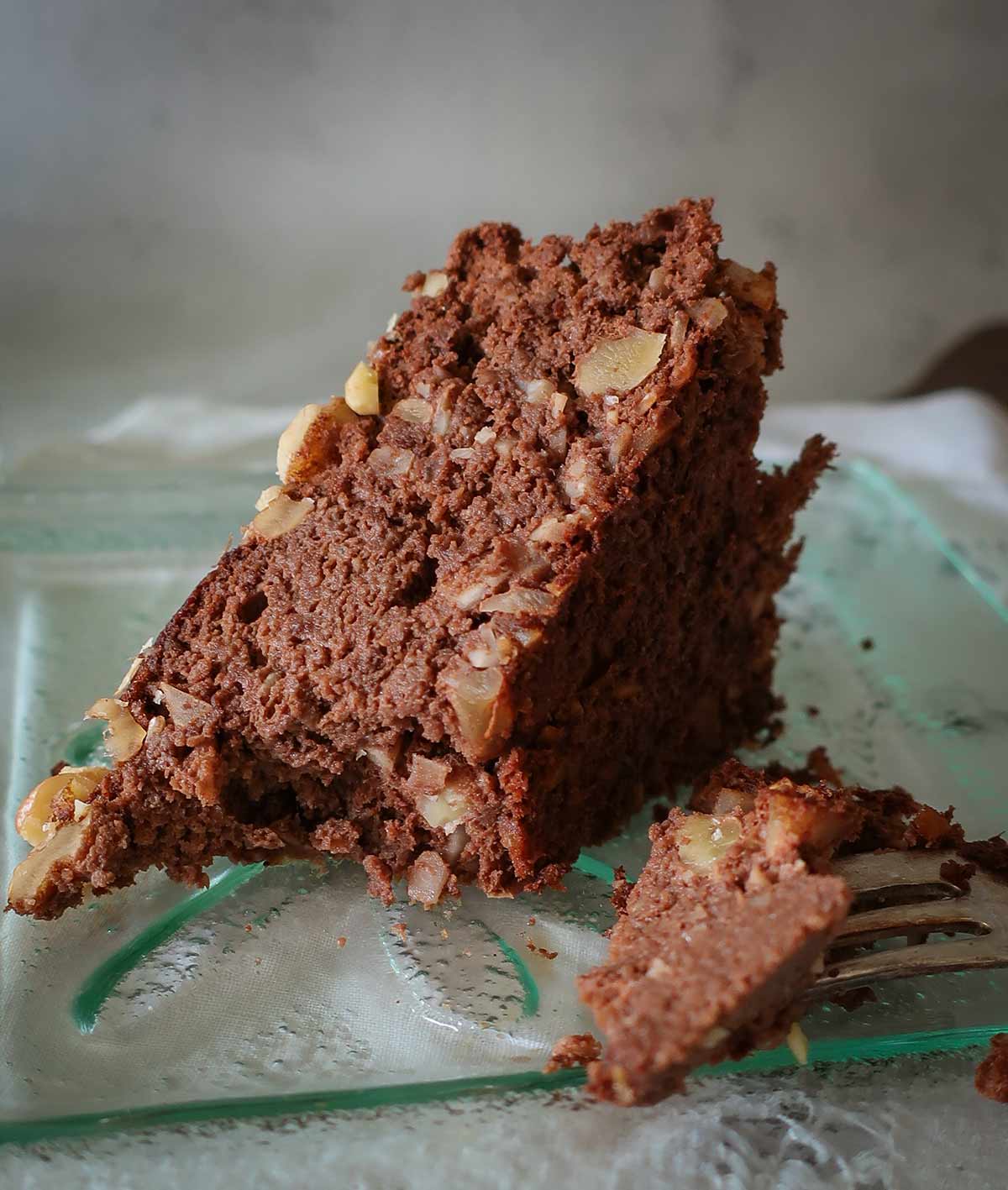 close up of a slice of gluten free fudgy protein banana cake on a dessert plate