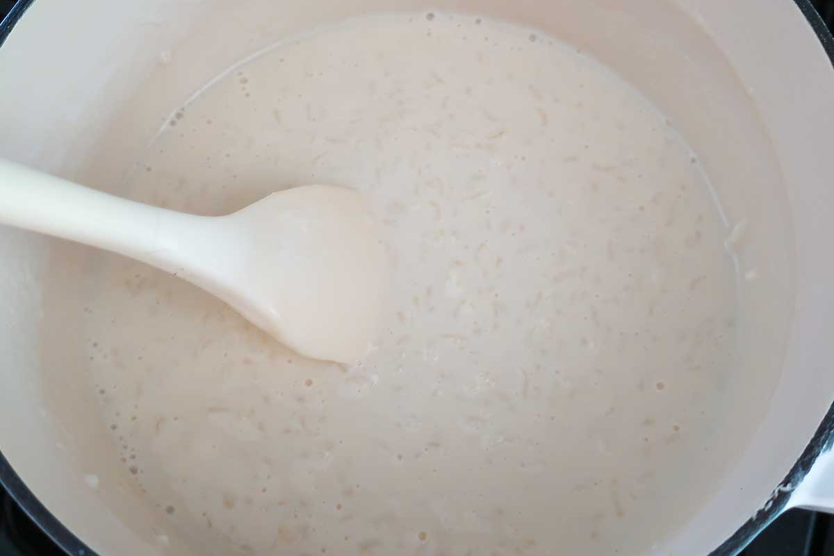 simmering rice with milk in a dutch oven opt showing milk rice ratio