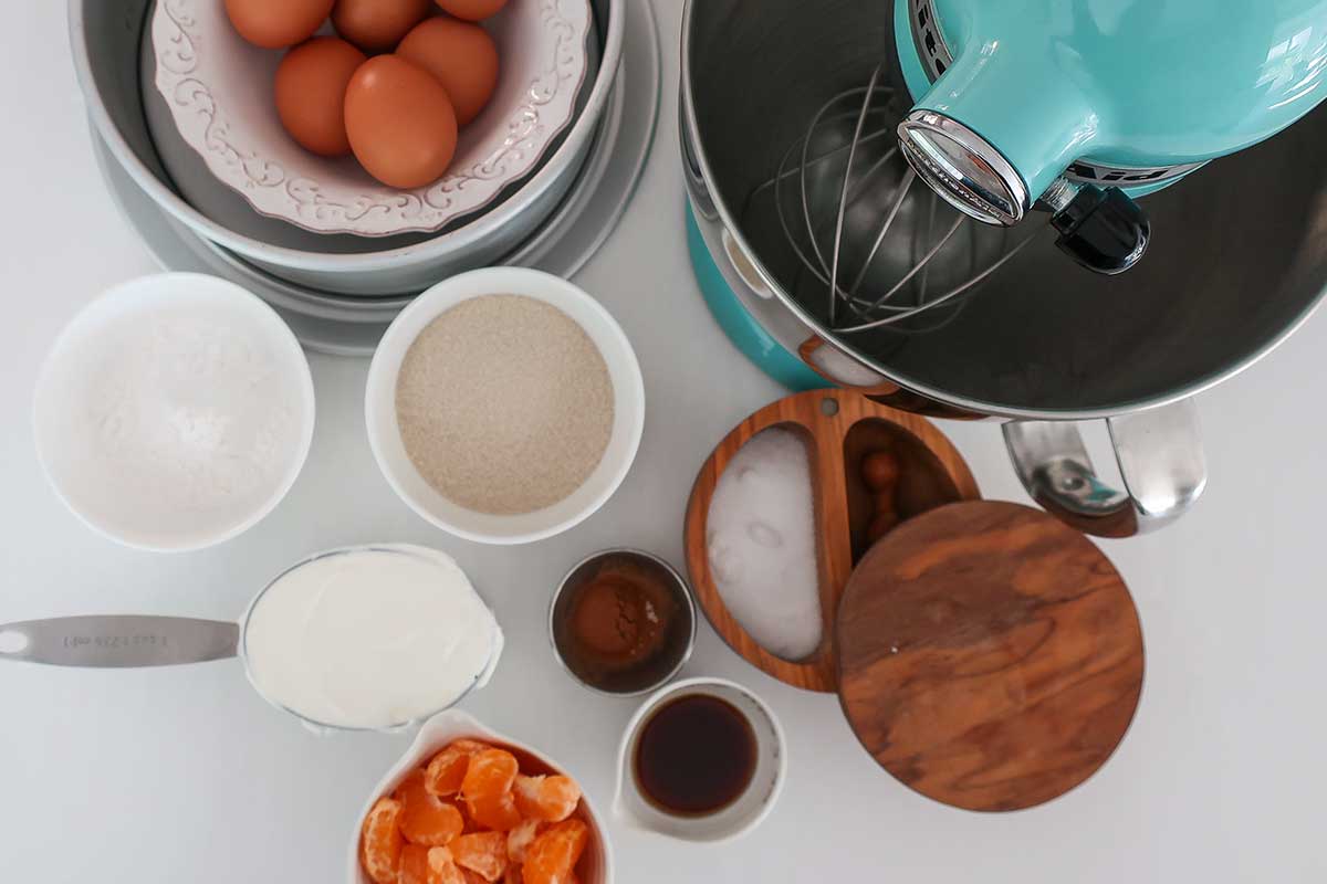 Flourless custard cake ingredients with mandarin oranges, eggs, sour cream, and tapioca starch