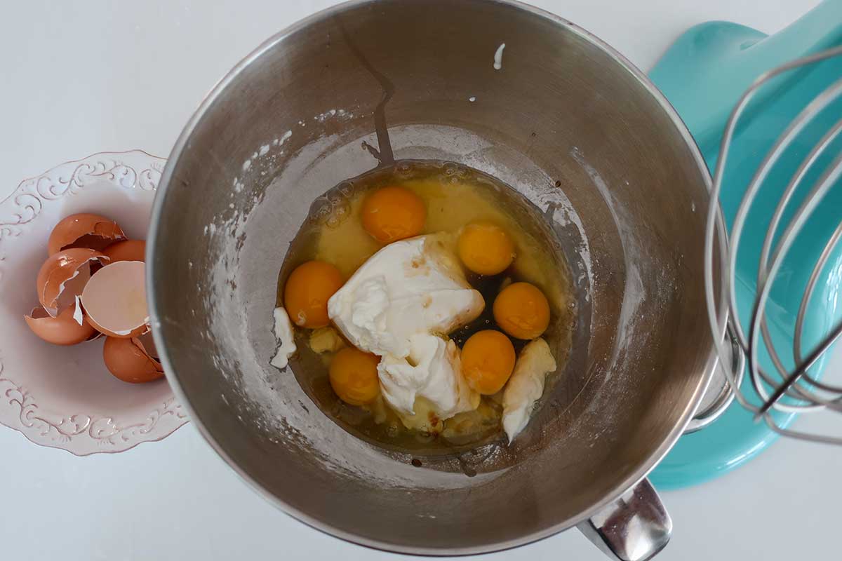 Eggs, sour cream, and vanilla in bowl for high-protein custard cake batter