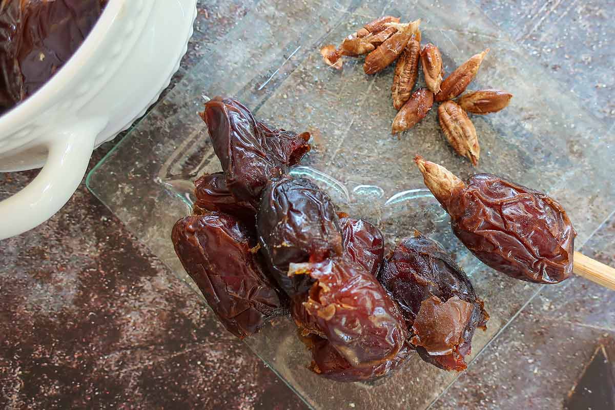 pitting dates with a chopstick through the stem
