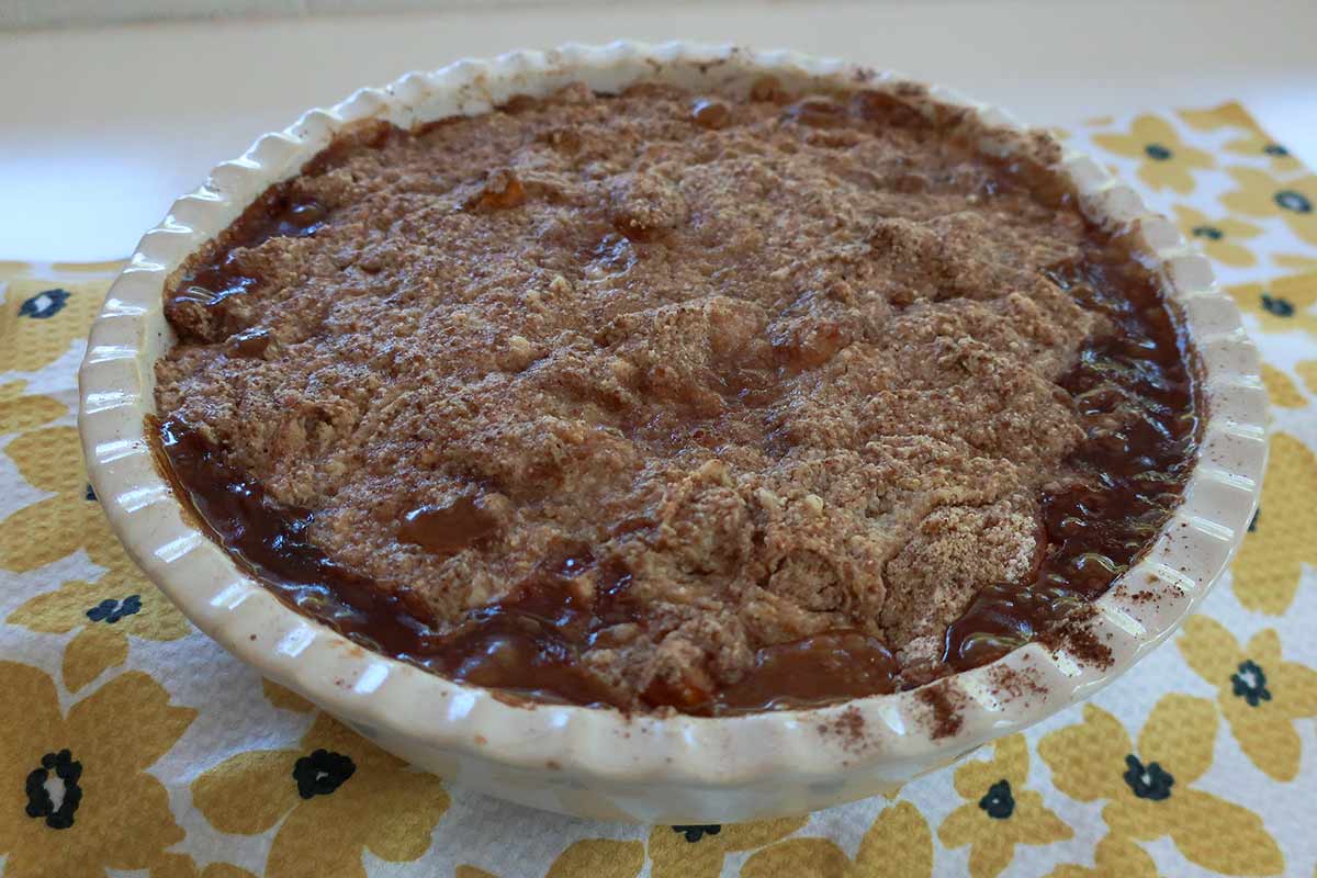 baked apricot cobbler style dump cake in a deep pie dish