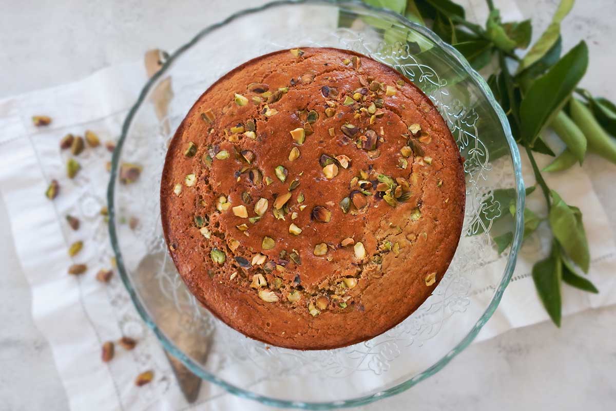 Finished whole pistachio cake on a cake platter