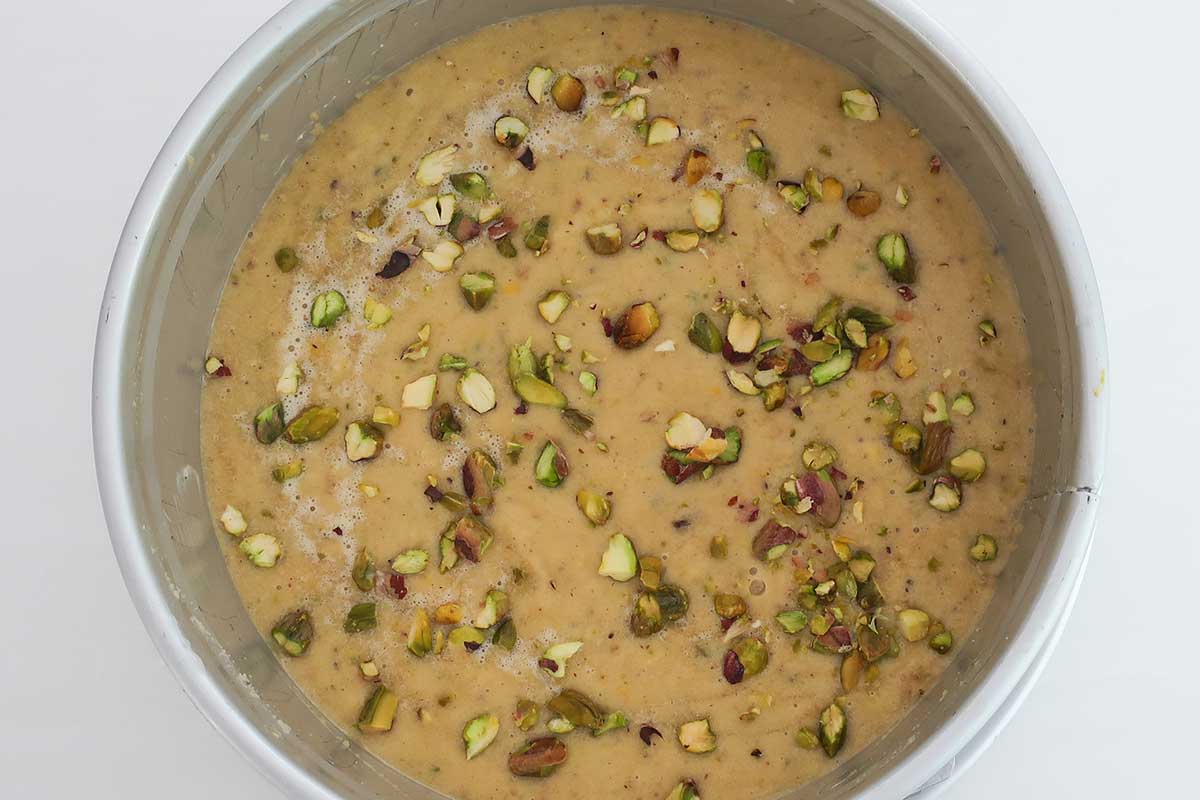 gluten free almond flour lemon pistachio cake batter in an 8" springform pan