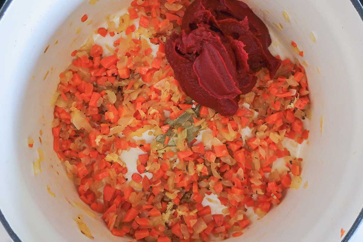 Sautéing the Soup Base, onion, carrots, garlic, spices and tomato paste in a pot