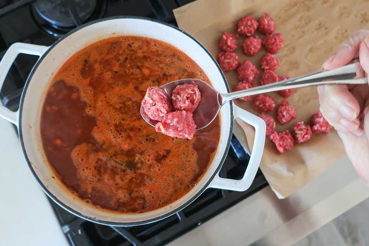 Adding the Meatballs to the Soup broth while it's simmering
