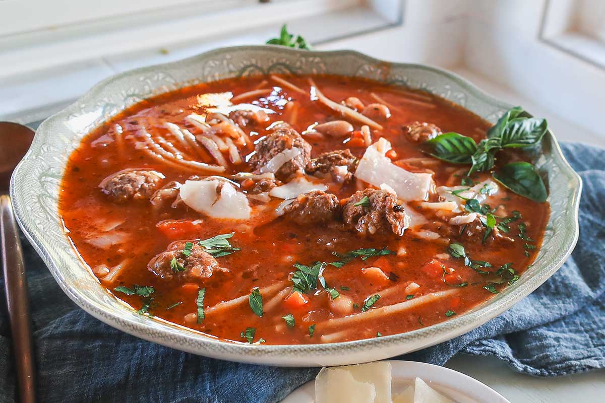 Kid-Friendly Gluten-Free Spaghetti Meatball Soup in a bowl topped with Parmesan