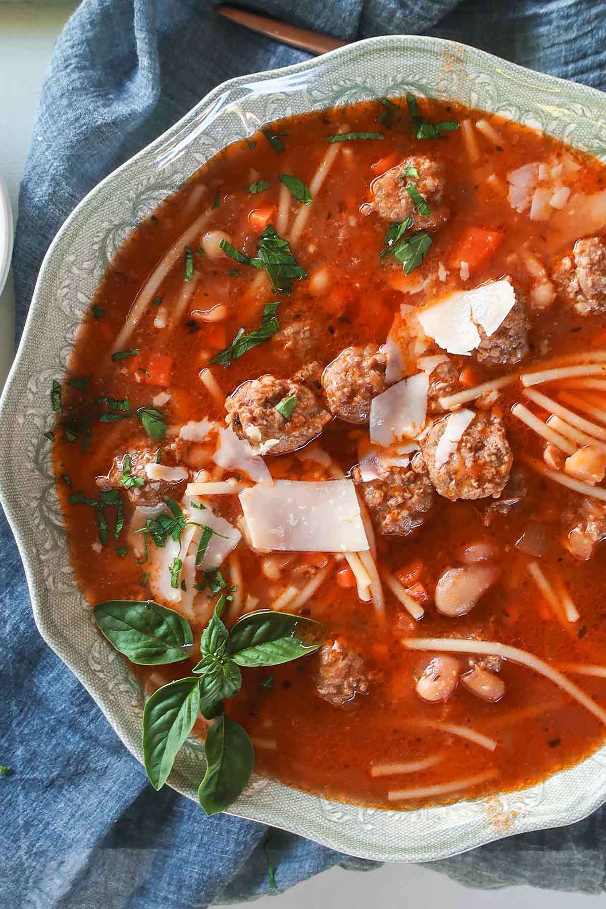 Gluten-Free Spaghetti Meatball Soup in a light tomato broth topped with Parmesan