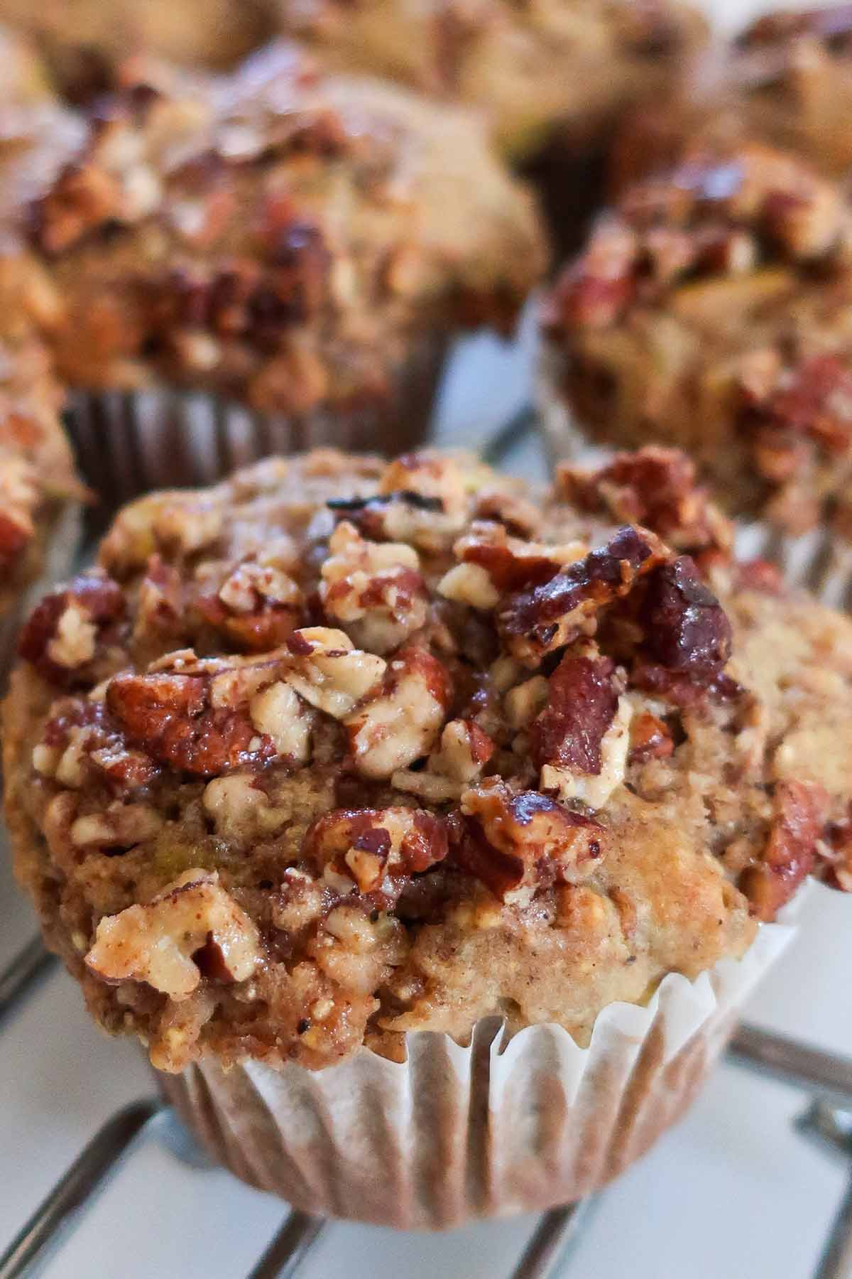 close up of Gluten-Free Apple Pecan Cornmeal Muffins topped with maple pecan crunchy topping 