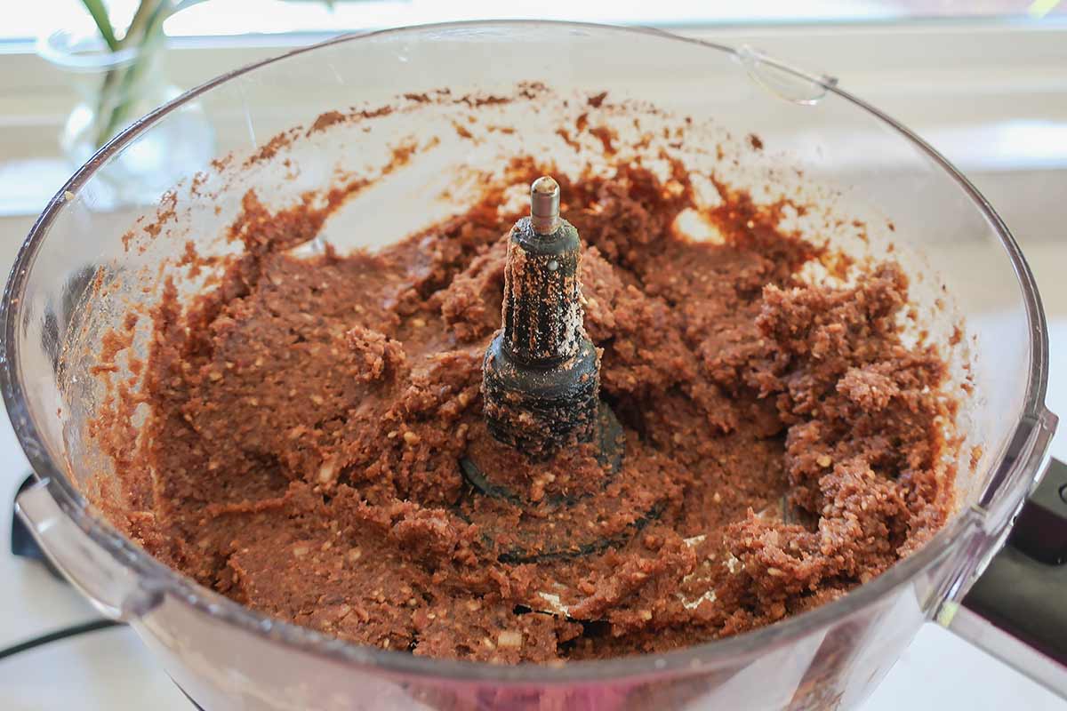 food processor filled with the thick fudgy mixture after processing the ingredients