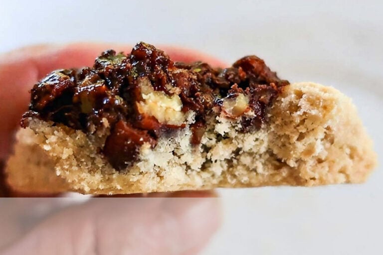 closeup showing the center of Gluten-Free Maple Pecan Pie Thumbprint Cookies with buttery texture and pecan pie topping