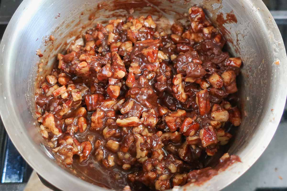 maple pecan mixture with partially melted chocolate chips in a small saucepan