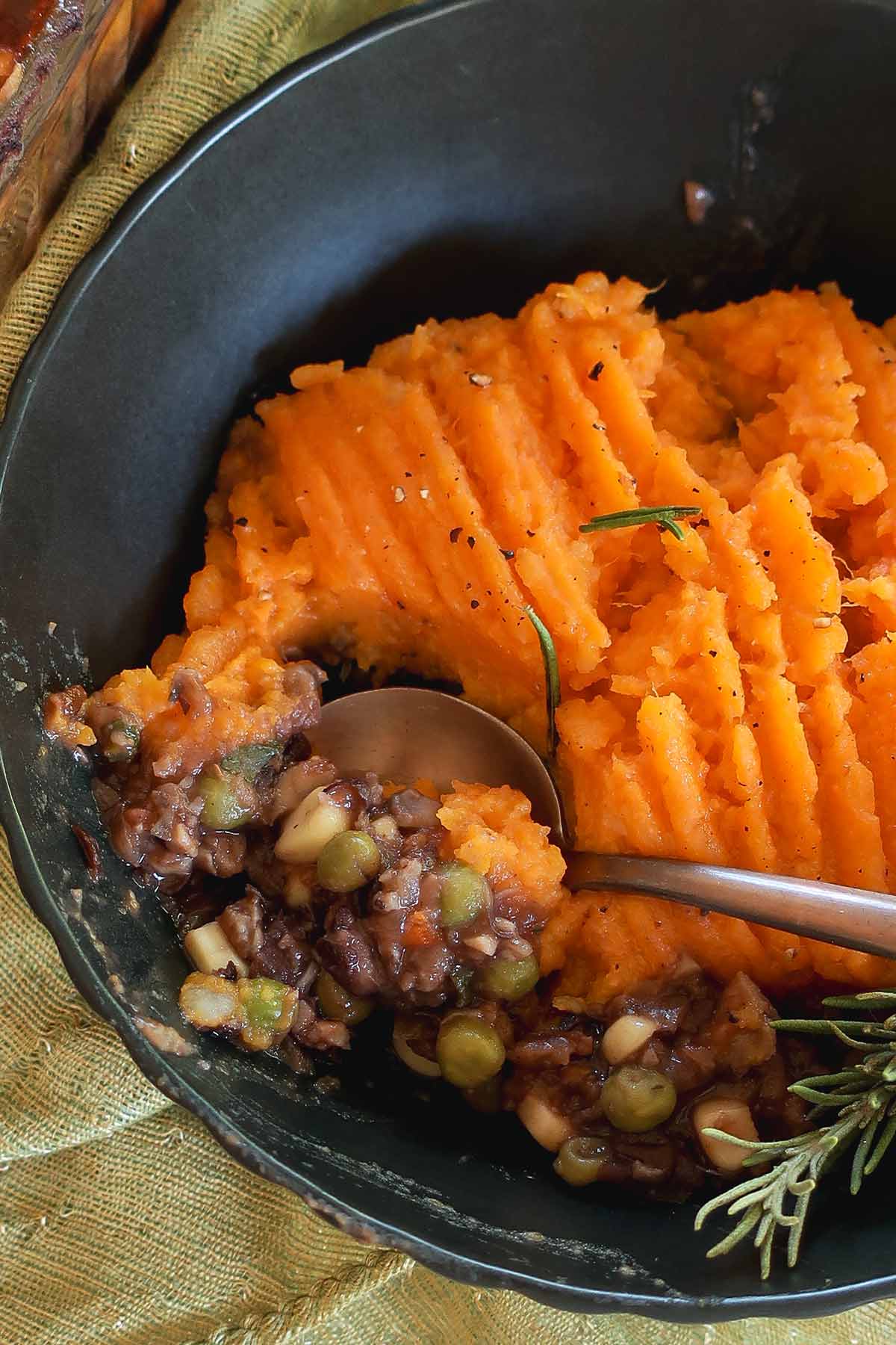 Sweet Potato Shepherd's Pie in a bowl showing thick saucy meatless filling 