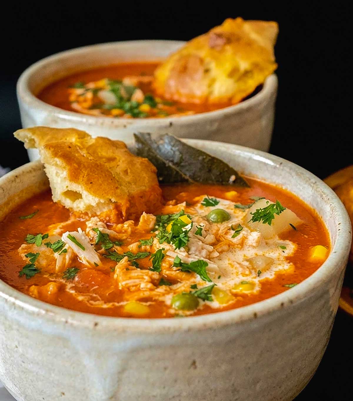 puff biscuits on top of tomato soup in a bowl