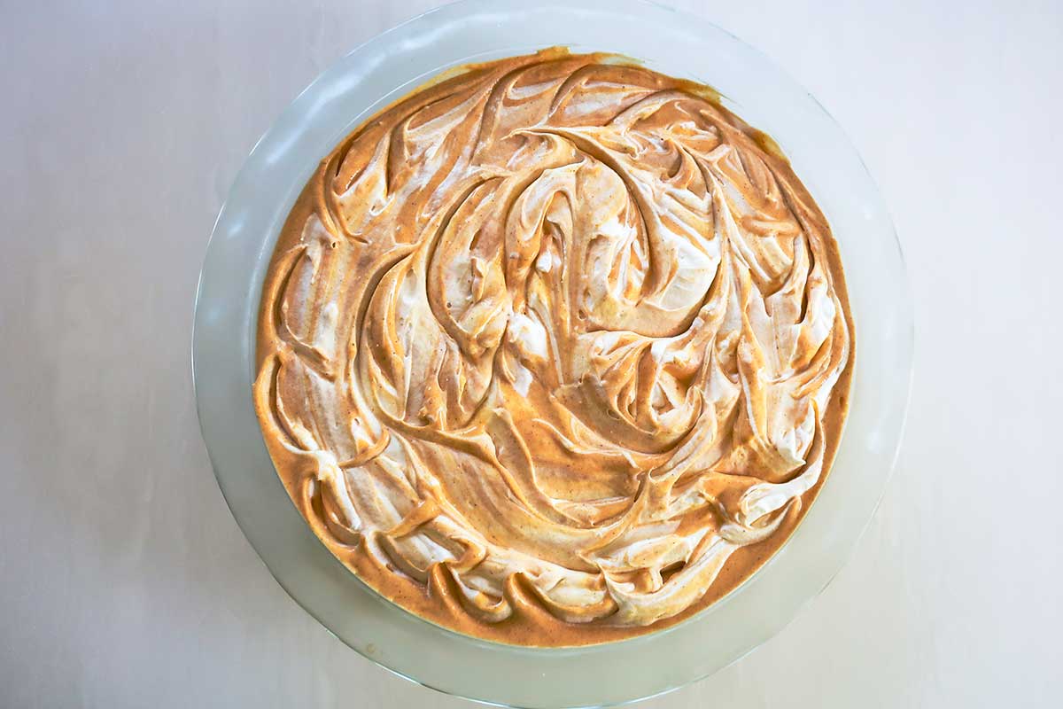 overhead view of No-Bake Gluten-Free Pumpkin Pie with whipped cream swirls and Almond Flour Crust 