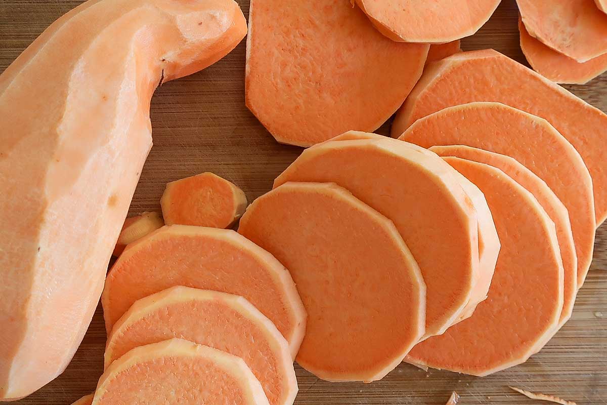 sliced into rounds Japanese sweet potato on a cutting board