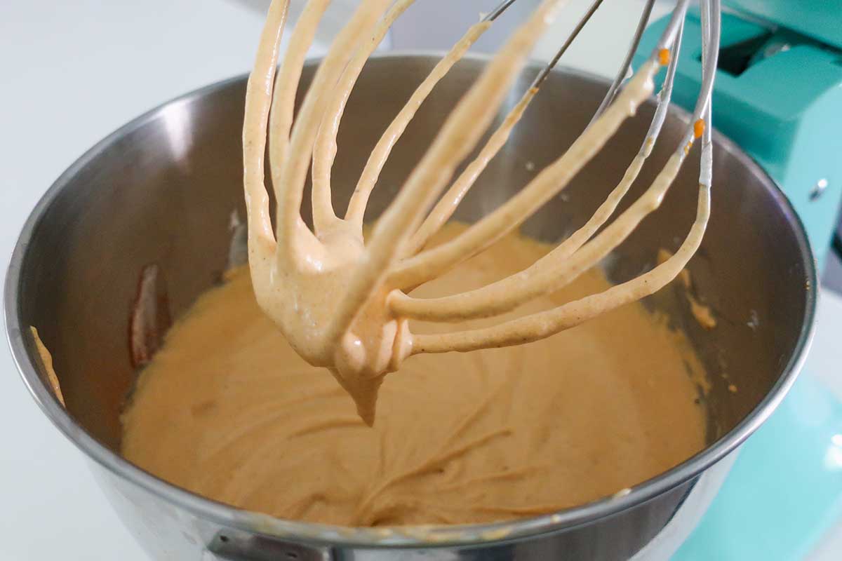 smooth pumpkin filling on a whisk showing the thick creamy texture