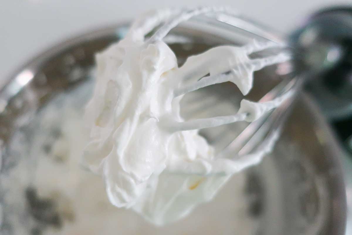 whipped cream with powdered sugar into soft peaks